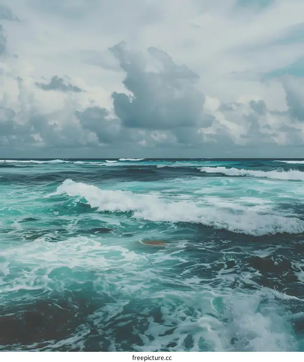 Blue Ocean Waves with White Foam under Cloudy Sky