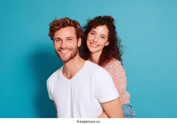 Couple Posing Against a Bright Blue Background