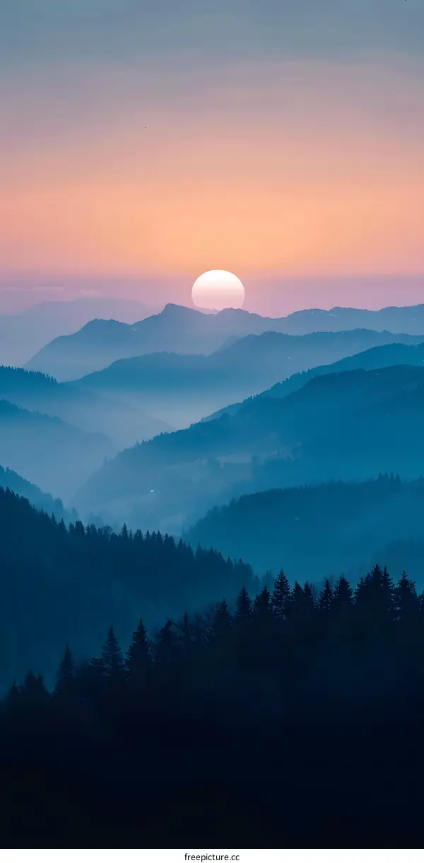 Misty Mountains at Sunset with a Sun in the Sky