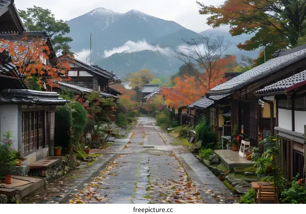 Traditional Japanese Village Street With Red Autumn Leaves and Mountain Background