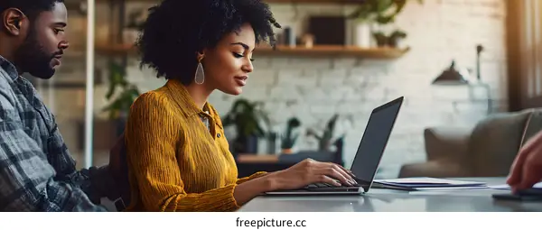 African American Couple Working on Laptop in Office
