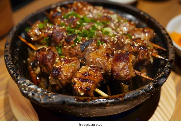 meat skewers on a hot stone plate