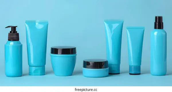 Blue cosmetic bottles and jars on blue background