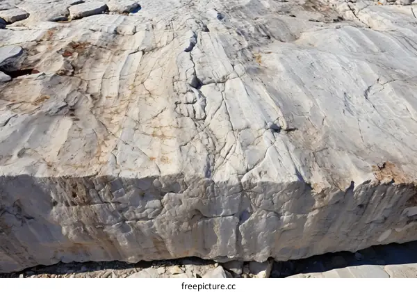 Large block of white marble with cracks and stains