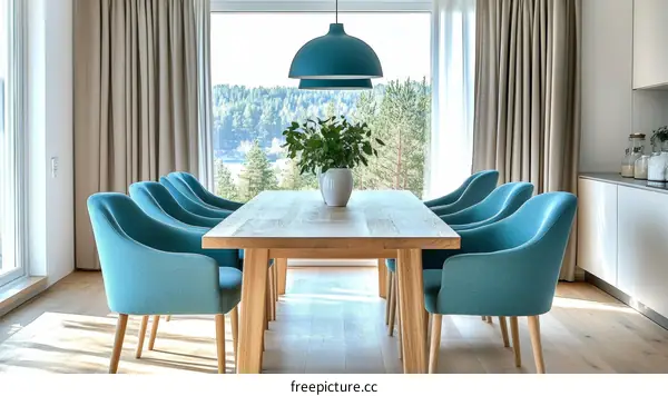 Modern Dining Room with Light Teal Chairs and Large Table