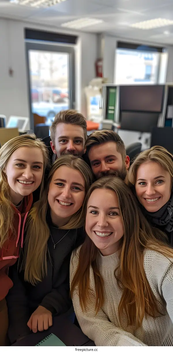 portrait of six smiling people in an office