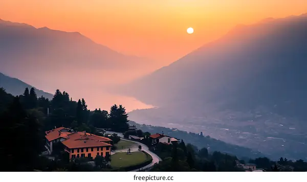Sunset over Lake District Mountains and Cityscape