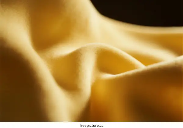 A Close-up View of Soft Yellow Textile with Wrinkles
