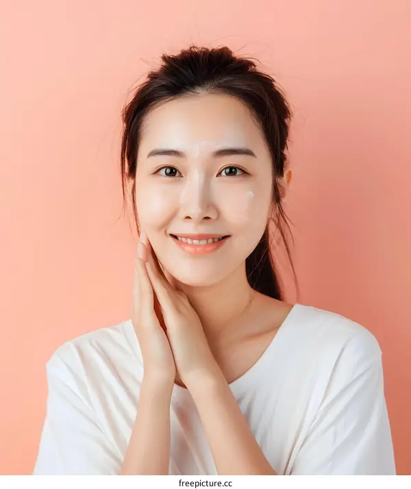 Smiling Asian Woman Applying Facial Cream