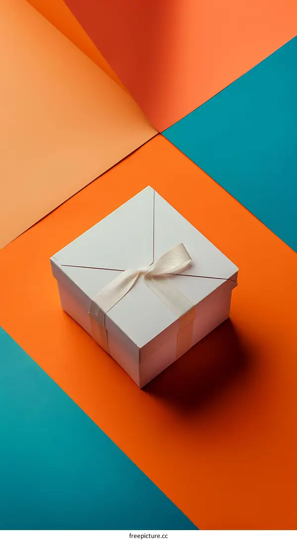 White Gift Box with Ribbon on Orange and Blue Background