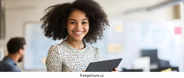 Smiling African American Woman Using Tablet In Office