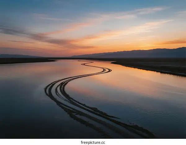 Serene Sunset Over a Winding River with Reflections