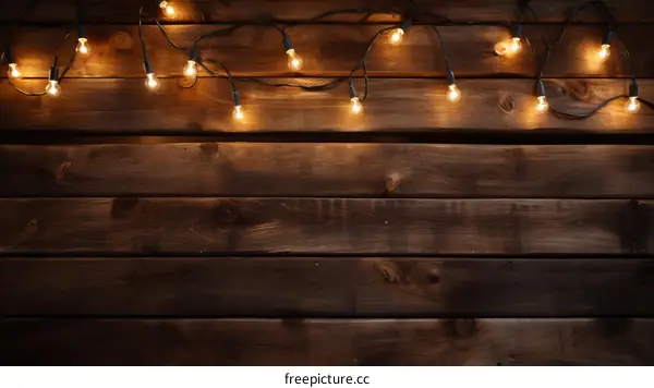 Warm and Cozy: Glowing Light Bulbs Hanging on a Wooden Background
