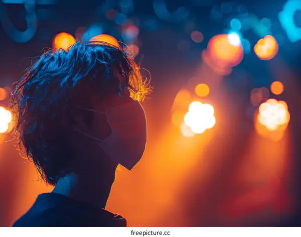 Close-up of a young man wearing a mask at a concert
