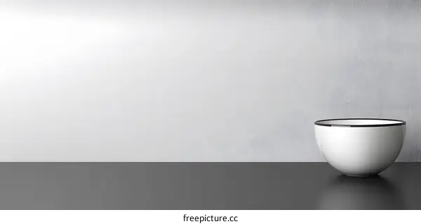 White Bowl With Black Rim on Black Surface