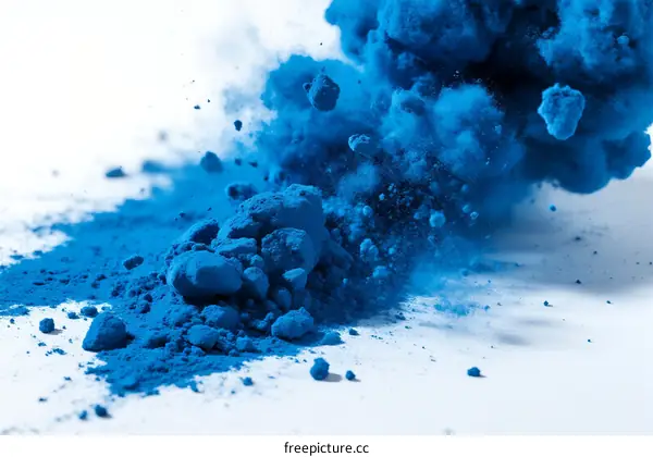 Vibrant blue powder explosion creating dynamic visual effect