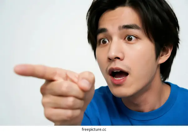 A man pointing with an expressive and surprised facial expression