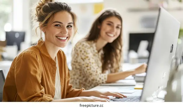 Two Women Colleagues Working at Desk