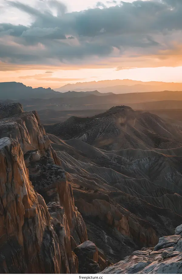 Mountain Range Landscape At Sunset With Cloudy Sky
