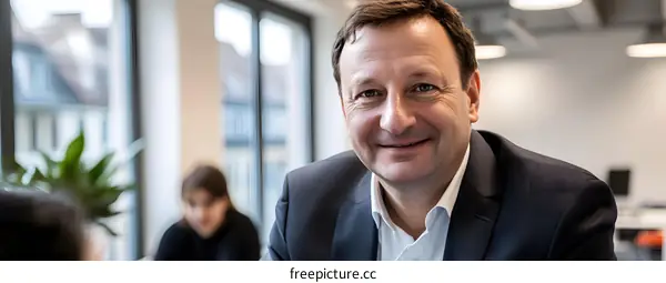 Smiling Businessman in Suit Looking at Camera