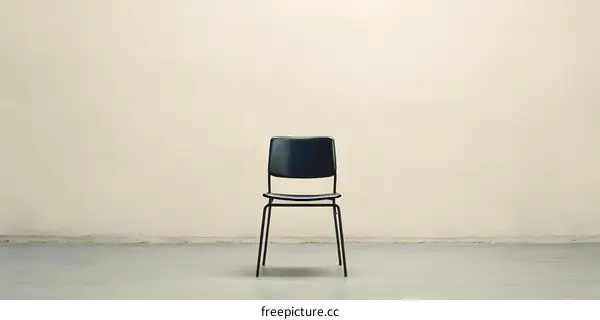 Empty Room with Single Chair on Concrete Floor