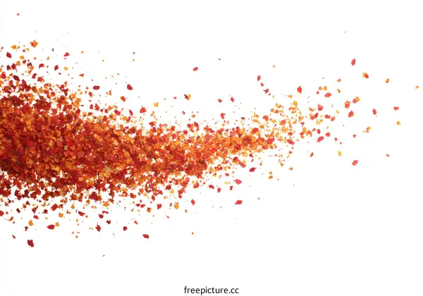 Red Chili Flakes Scattered on White Background