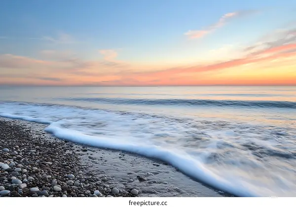 Calm Ocean Waves Crashing on the Beach at Sunrise