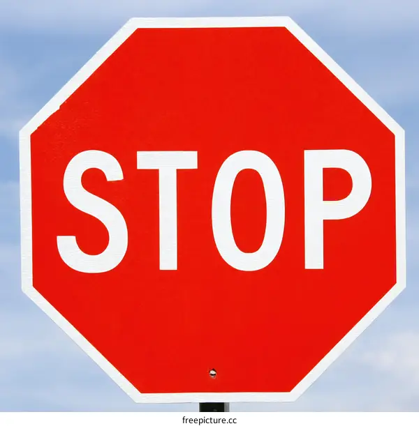 Octagonal Red Stop Sign Against Sky