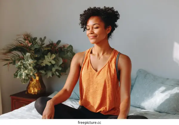 Peaceful Black Woman Meditating in Her Bedroom