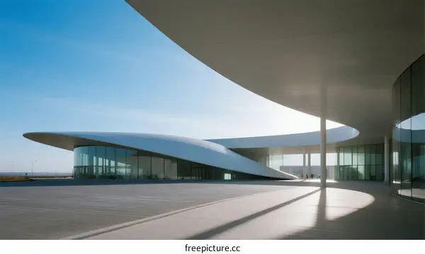 Modern Architectural Design with Curved White Structures Under Blue Sky