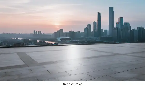 City skyline at sunset with modern buildings and empty ground