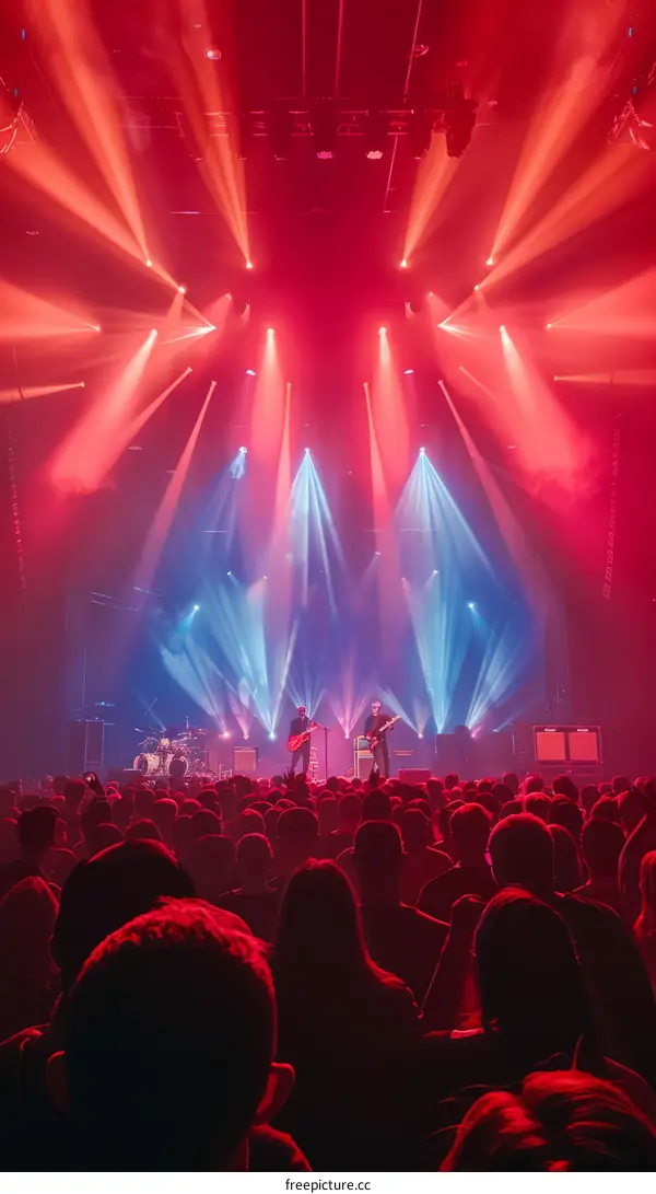 Red and blue stage lights in a concert with many people