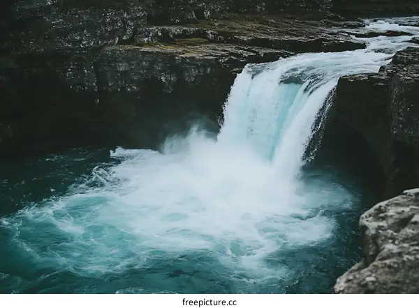 Waterfall Flowing Over Rocks In Nature