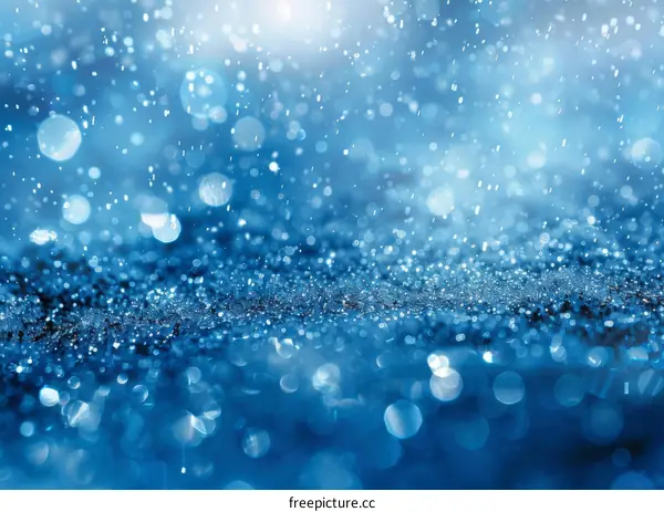 Blue water drops falling on a blue surface with a blurred background