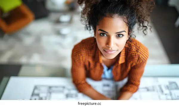 Focused Woman Architect Working on Plans