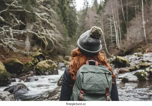 Woman with Backpack Hiking in the Forest
