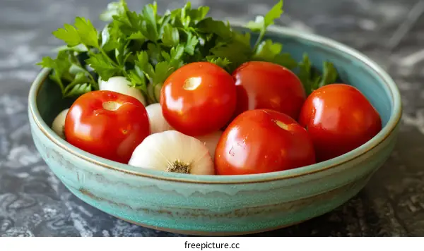 A bowl of tomatoes, garlic, and parsley