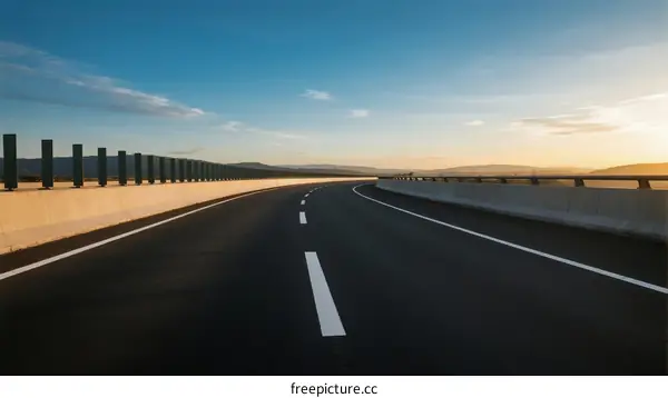 Smooth Asphalt Road Under Clear Blue Sky with White Lines