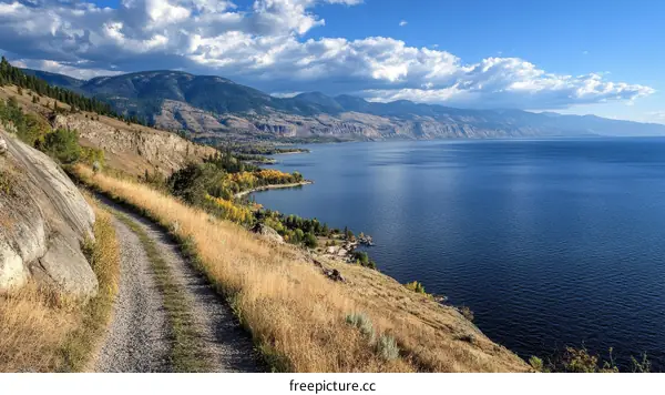 Scenic Lakeside Trail Overlooking Mountainous Landscape