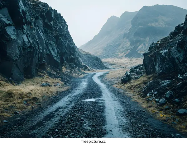 A winding dirt road through a mountain pass in Iceland