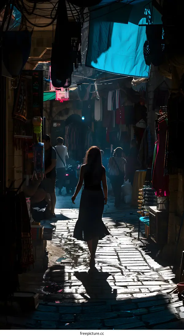 Woman Walking Through a Narrow Street in Middle Eastern Market