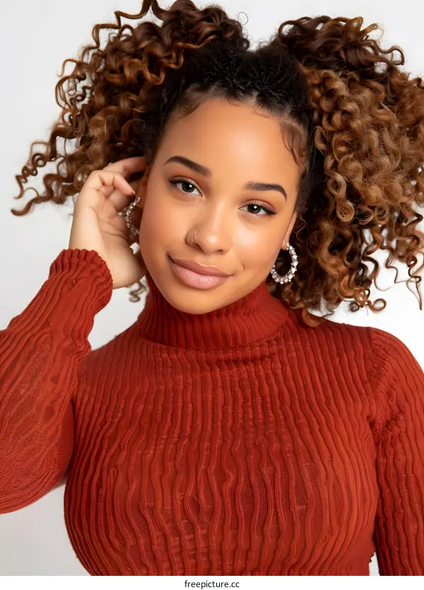 Portrait of a Young Black Woman with Curly Hair Wearing a Red Sweater