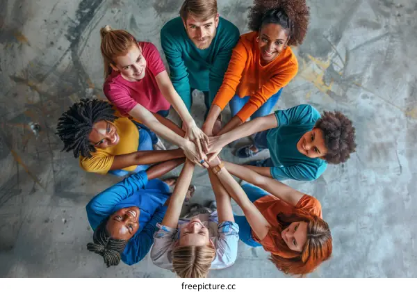 Multiethnic group of people joining hands together