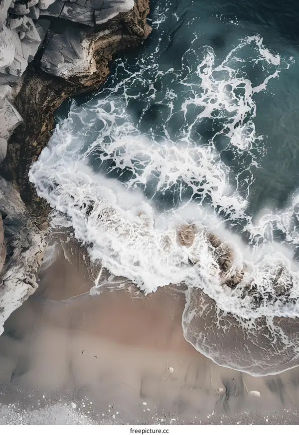 Aerial View of White Waves Crashing on Sandy Beach
