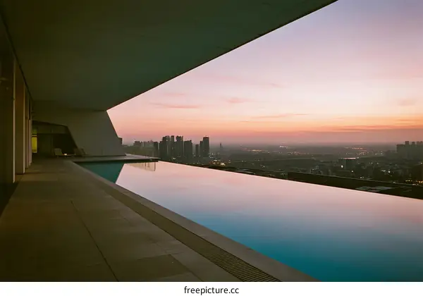Infinity Pool with Urban Skyline View at Sunset