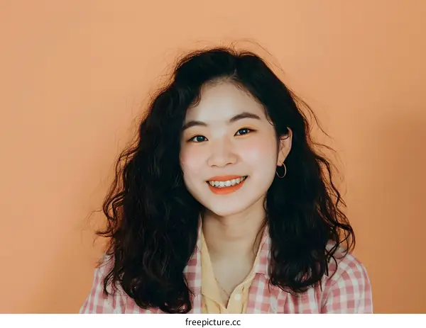 Portrait of a Smiling Asian Woman with Curly Hair