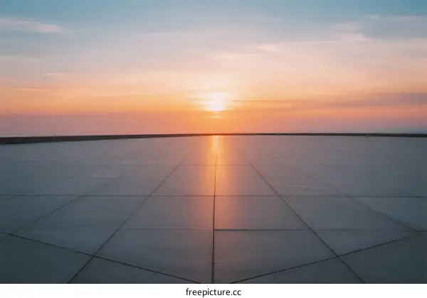 The beautiful sunset over the smooth concrete ground