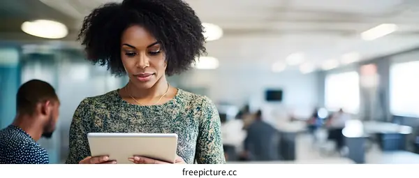 African American Woman Working on Tablet in Office