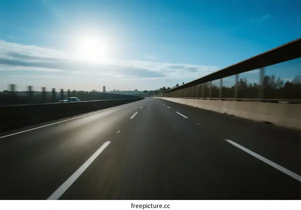 Sunny highway with clear blue sky and empty road ahead