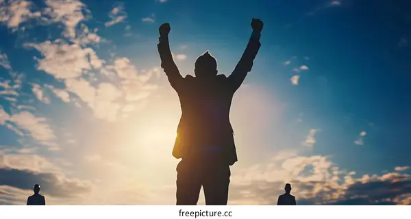 Man Silhouette Raising Hands to Sky at Sunset